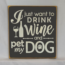Load image into Gallery viewer, “I Just Want to Drink Wine and Pet My Dog” Funny handcrafted wood sign with an adorable paw print stamp and an image of a wine glass and bottle, 12x12 inches white font over Black. Rustic modern farmhouse home décor
