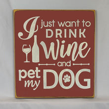 Load image into Gallery viewer, “I Just Want to Drink Wine and Pet My Dog” Funny handcrafted wood sign with an adorable paw print stamp and an image of a wine glass and bottle, 12x12 inches white font over Dark Red. Rustic modern farmhouse home décor
