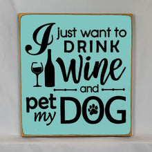 Load image into Gallery viewer, “I Just Want to Drink Wine and Pet My Dog” Funny handcrafted wood sign with an adorable paw print stamp and an image of a wine glass and bottle, 12x12 inches white font over Key West Blue. Rustic modern farmhouse home décor
