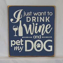 Load image into Gallery viewer, “I Just Want to Drink Wine and Pet My Dog” Funny handcrafted wood sign with an adorable paw print stamp and an image of a wine glass and bottle, 12x12 inches white font over Navy Blue. Rustic modern farmhouse home décor
